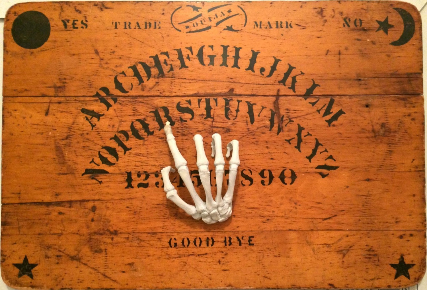 The skeletal planchette on an original 1890 Ouija board, made before the trademark was issued